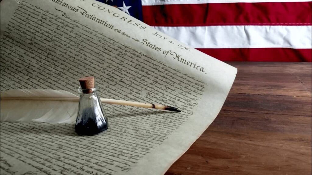 Printed copy of Declaration of Independence with quill and ink