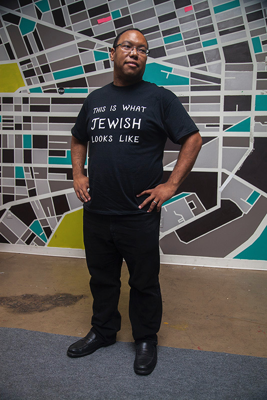 Jared Jackson, founder of Jews in All Hues, sports a shirt that says "this is what Jewish looks like." 