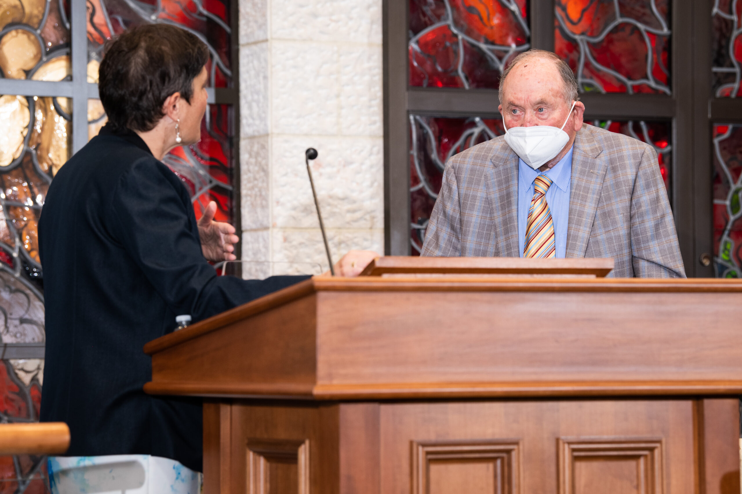 Rabbi Deborah Waxman shares the bimah with Donald Shapiro, who is wearing a mask. 
