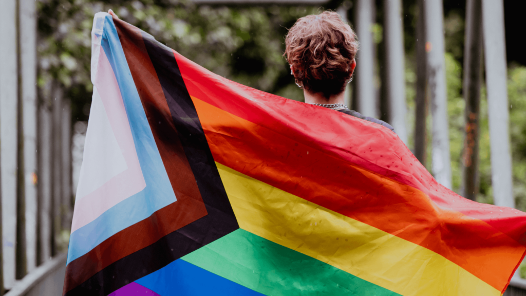 person holding a Pride flag