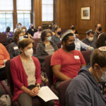 Students and staff gather in RRCs community room for the art installation program.