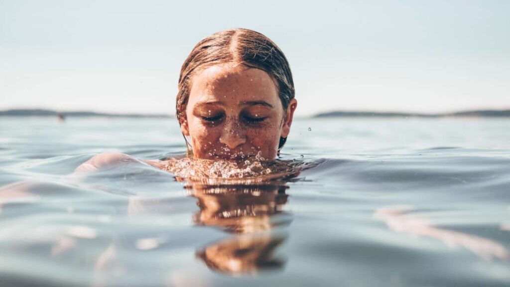 Young woman swimming in a lake