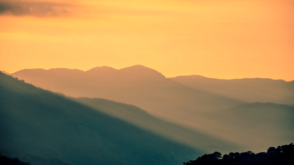 Sunrise over a mountain range from a distance