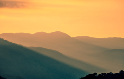 Sunrise over a mountain range from a distance