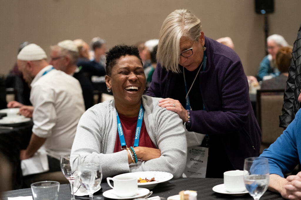 Rabbi Sandra Lawson, seated and smiling, with Christina Ager, at the 2022 convention.