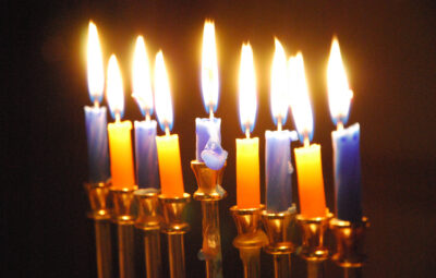All candles lit on a hanukkiyah