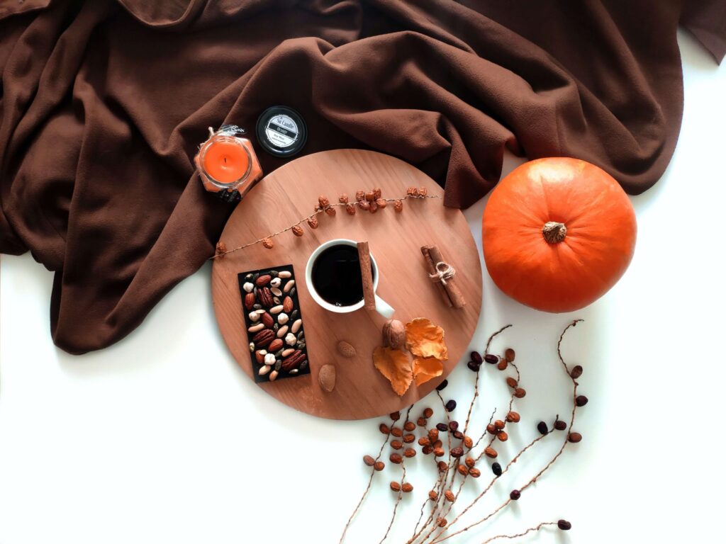 an autumn tablescape with a brown cloth and orange pumpkin