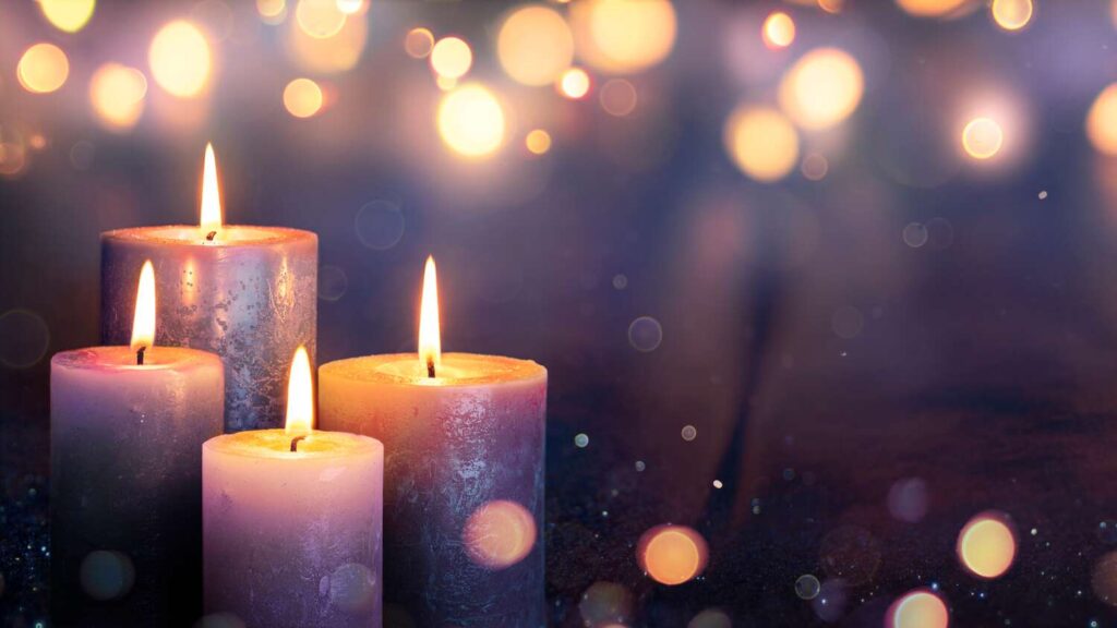 Four candles with shimmering lights