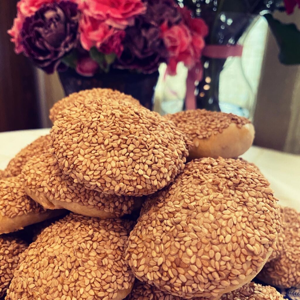 Mizrakhi Cookies on a blue and white plate with flowers behind