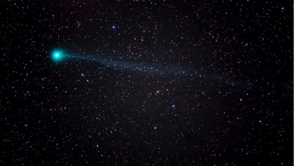 A view of space with one very bright blue light among lots of stars