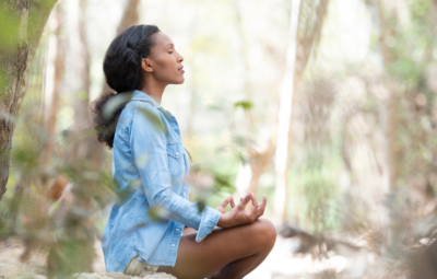 woman meditating in the forest