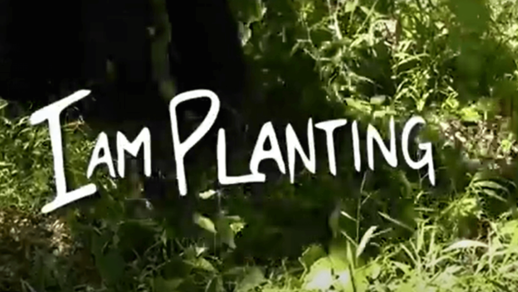The words "I am Planting" overlaid on grass and bushes