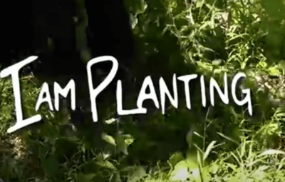 The words "I am Planting" overlaid on grass and bushes