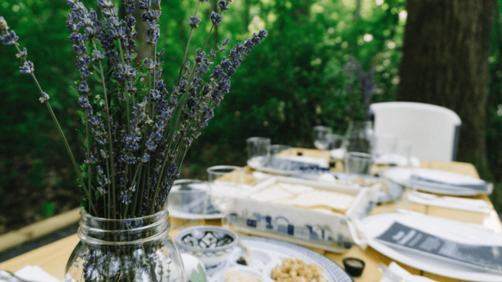 A seder table with plants and dishes.