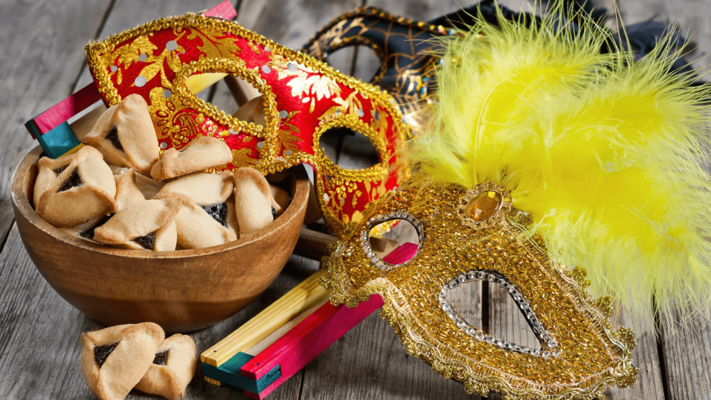 An assortment of colorful Purim masks, groggers, and hamentashen