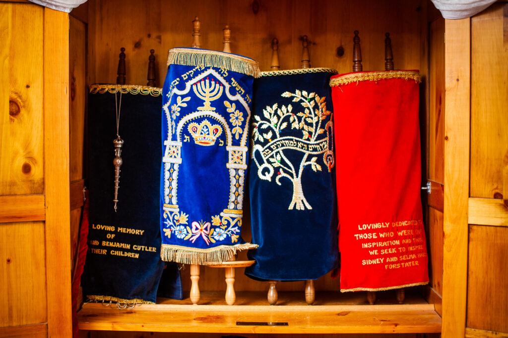 Four Torah scroll stands side-by-side in the wooden ark at the Reconstructionist Rabbinical College.