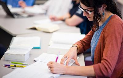 Rabbinical student writing at desk