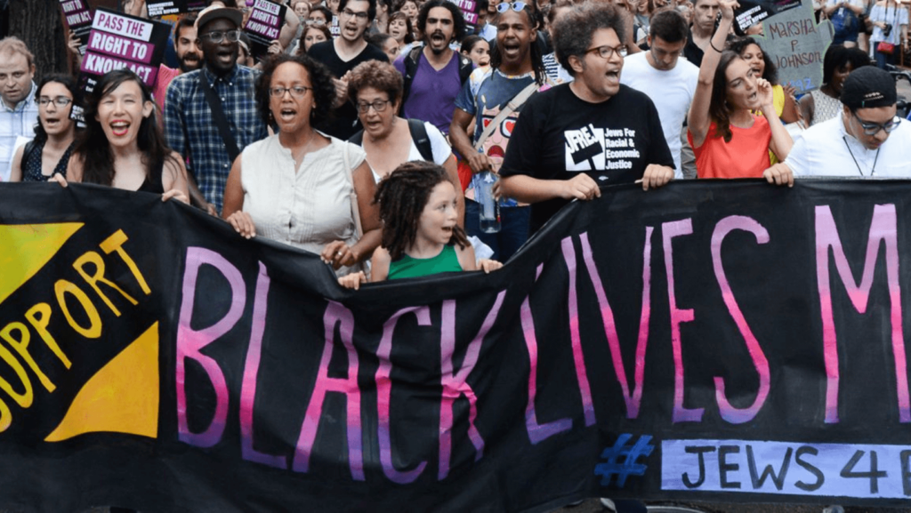 A group demonstrates under the banner, Jews 4 Black Lives Matter.