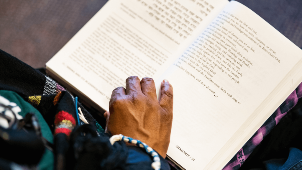 Close-up of a Black person reading a book