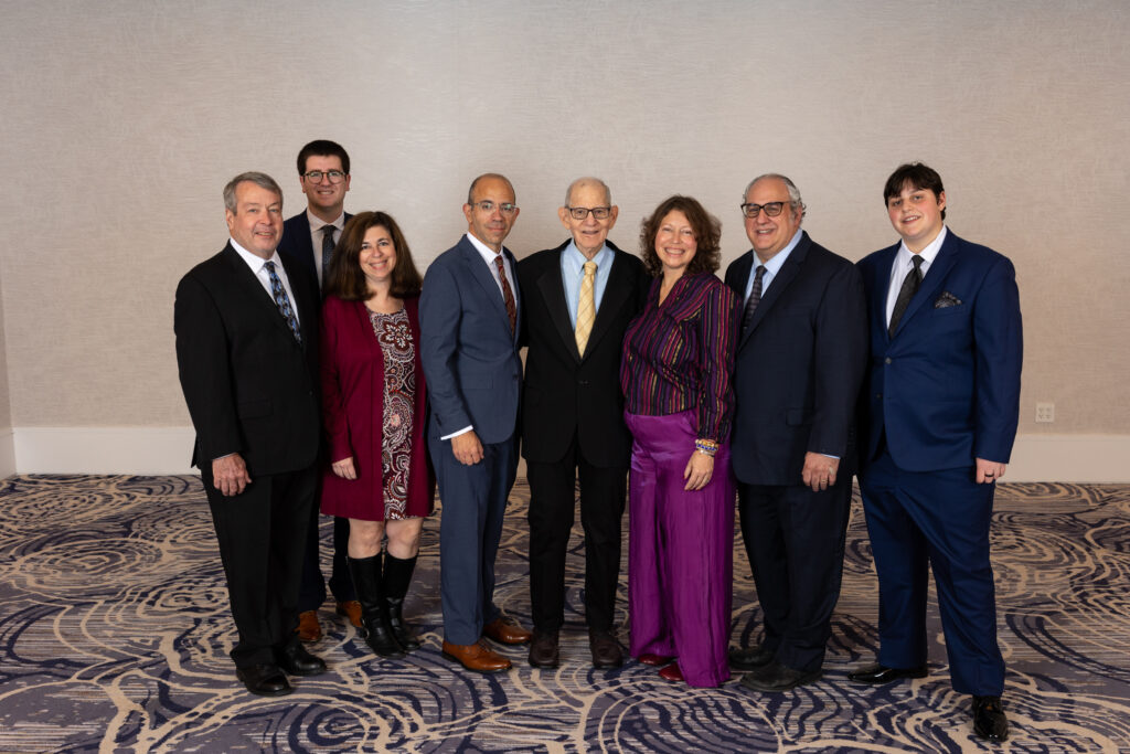 Gabrielle Kaplan-Mayer and extended family in formal dress.