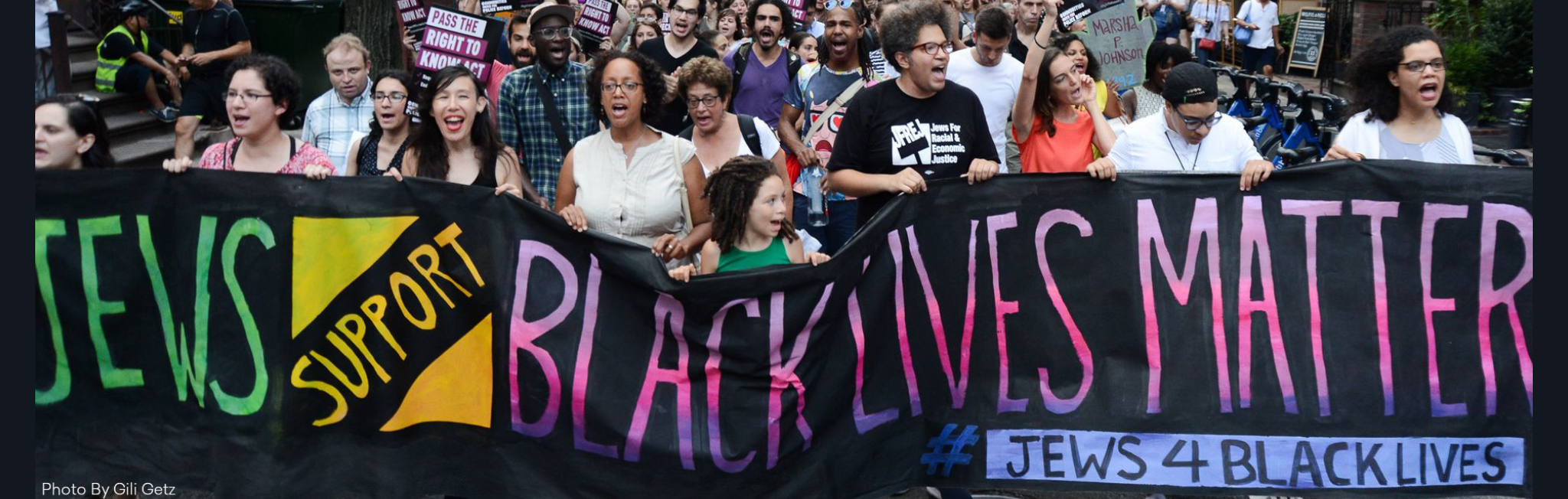 Protesters hold a banner reading Jews Support Black Lives Matter during a march.