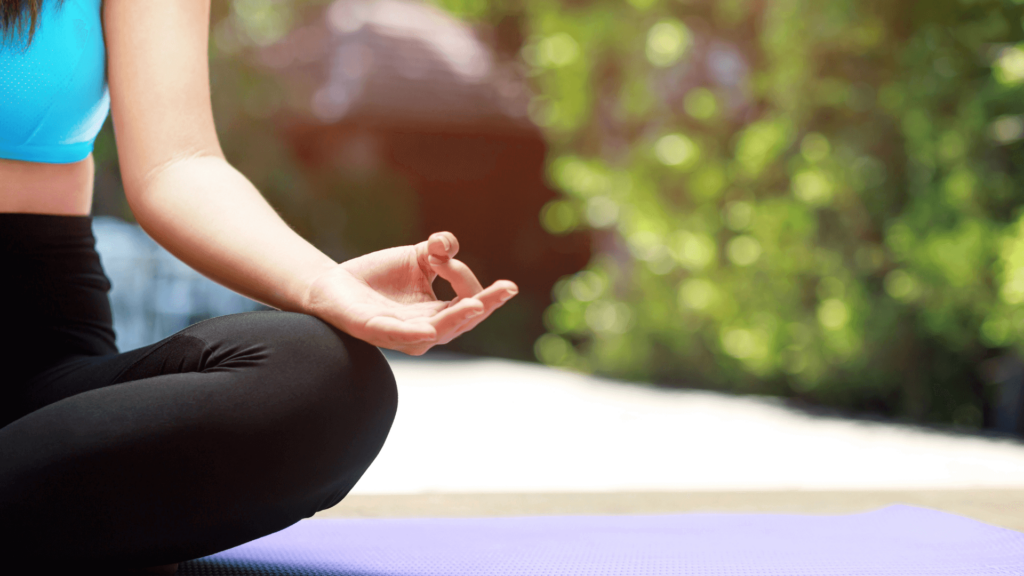 Close-up of a woman meditating on a yoga mat