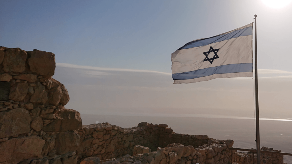 Israeli flag flying on a rocky outcropping