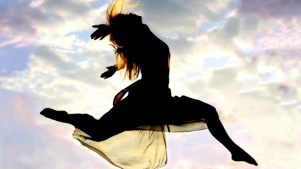 Silhouette of a person leaping against a sky background