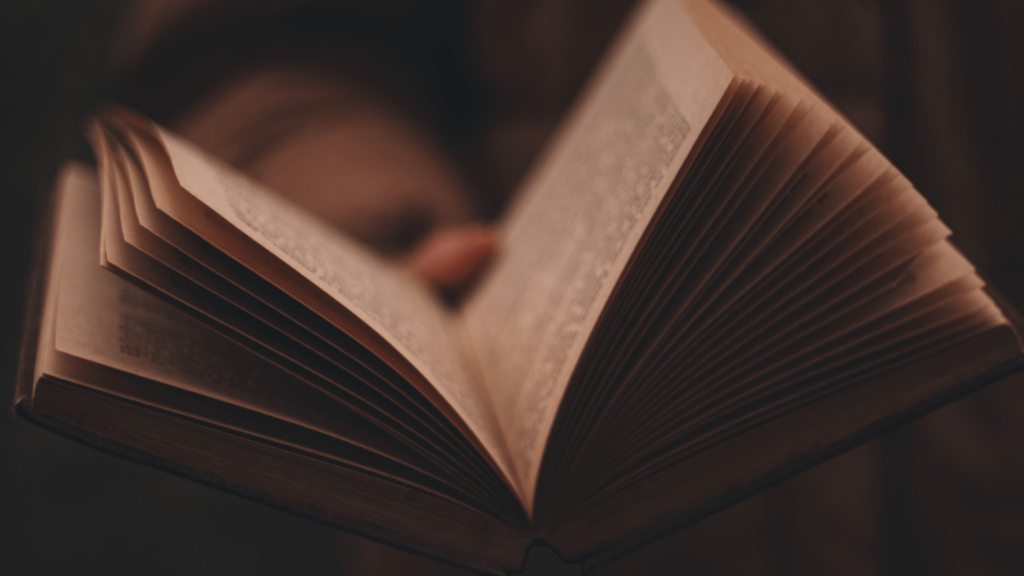 Close-up of someone holding an open book of poetry