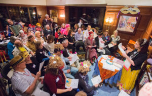 Overhead view of an Or Zarua Purim party, with most people wearing costumes.