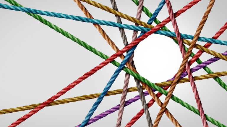 Colorful ropes crisscross against a light gray background, creating a network of intersecting lines.