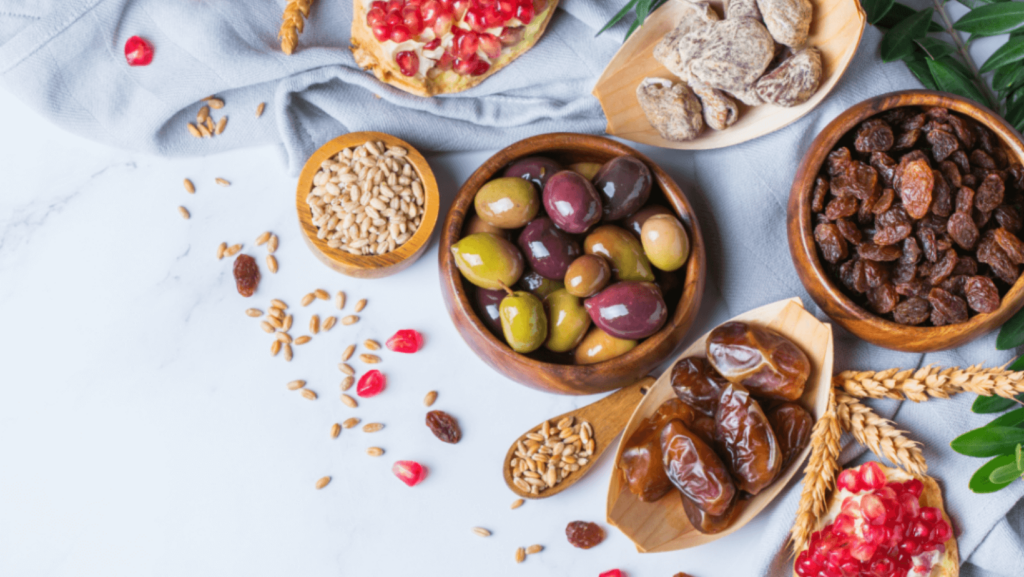 Dishes of food such as nuts, dates, pomegranates, and dried fruit