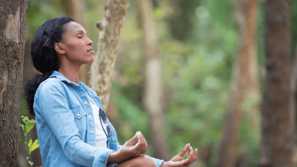 Black woman meditating outdoors