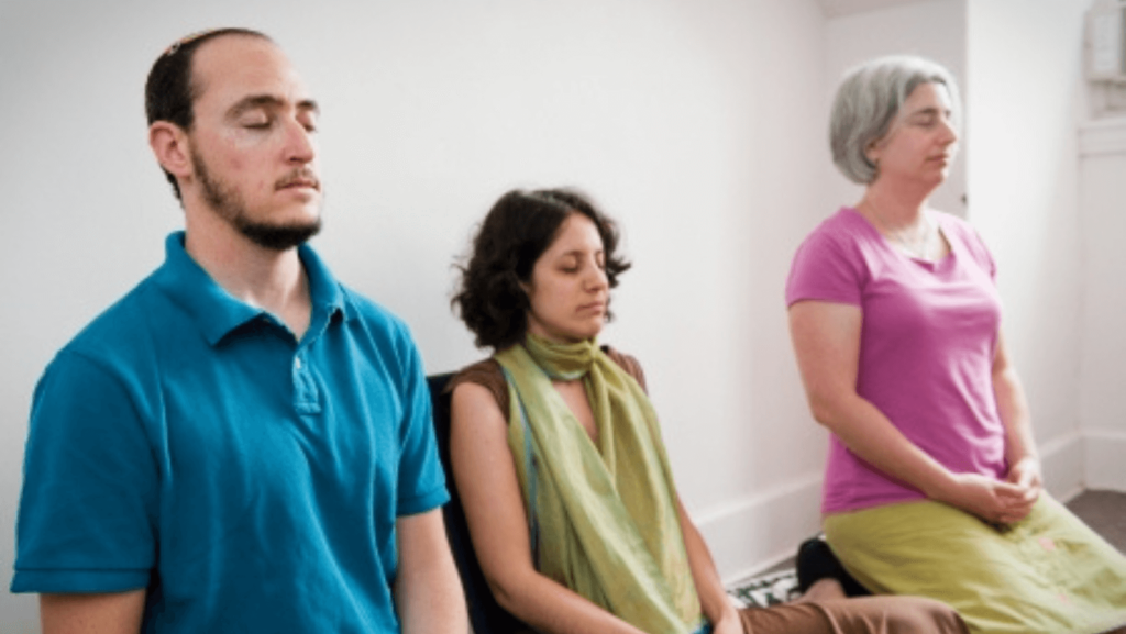 Three people meditating