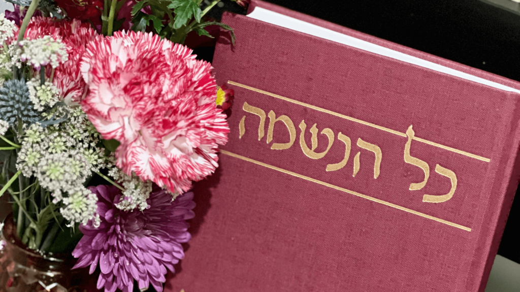 A prayerbook with pink and purple flowers