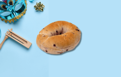 Blueberry bagel and grogger on a blue background