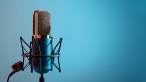 A vintage-style microphone on a stand against a blue gradient background.
