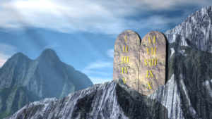 Stone tablets with Roman numerals on a mountain under a blue sky.