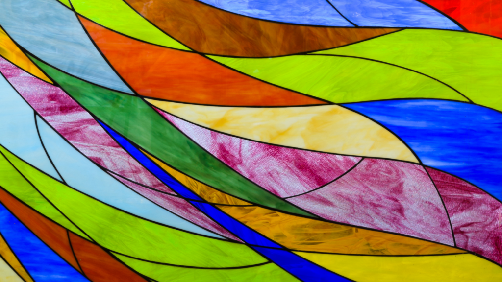 Abstract stained glass art with vibrant colors and flowing geometric shapes.