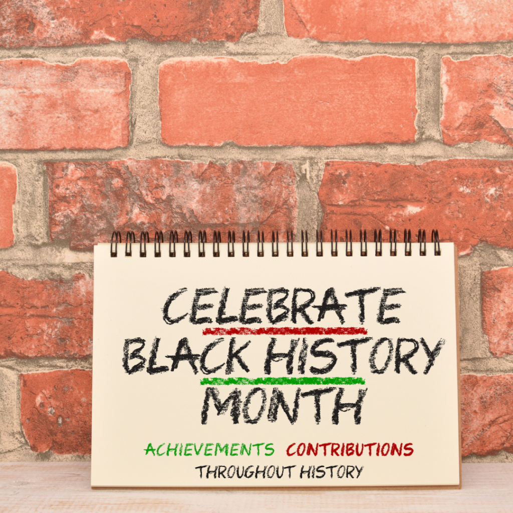 Notebook against a brick wall with the text Celebrate Black History Month emphasizing achievements and contributions.