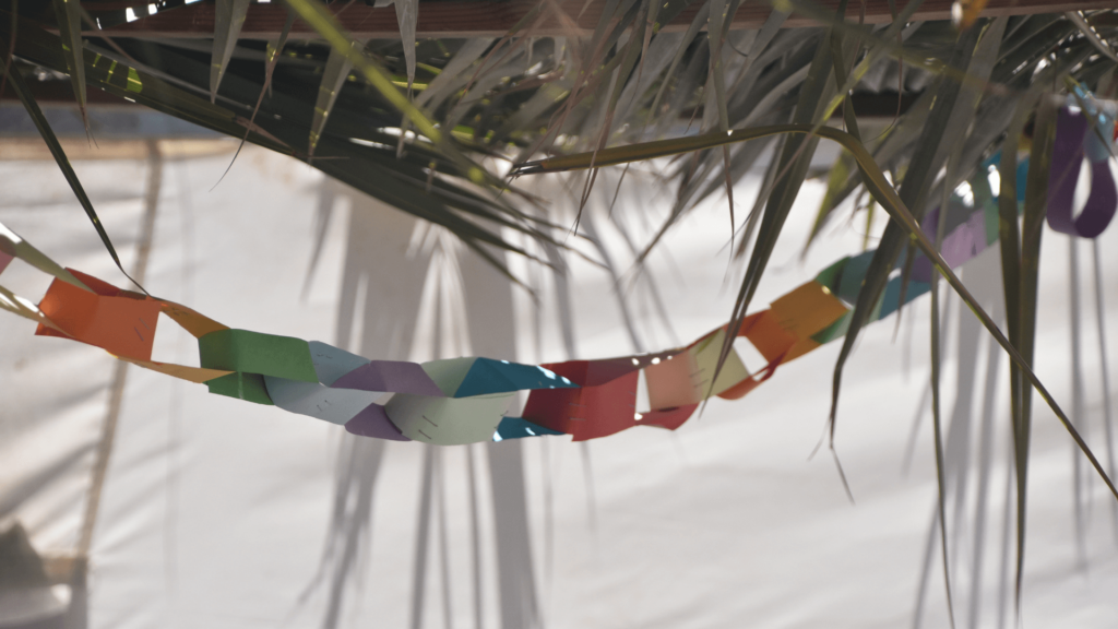 A handmade paper chain inside a sukkah