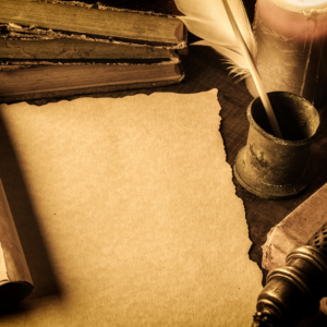 Vintage writing setup with blank paper, open books, quill in inkwell, and candle on a dimly lit desk.
