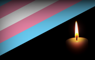 Transgender flag diagonal with a glowing candle on a black background.
