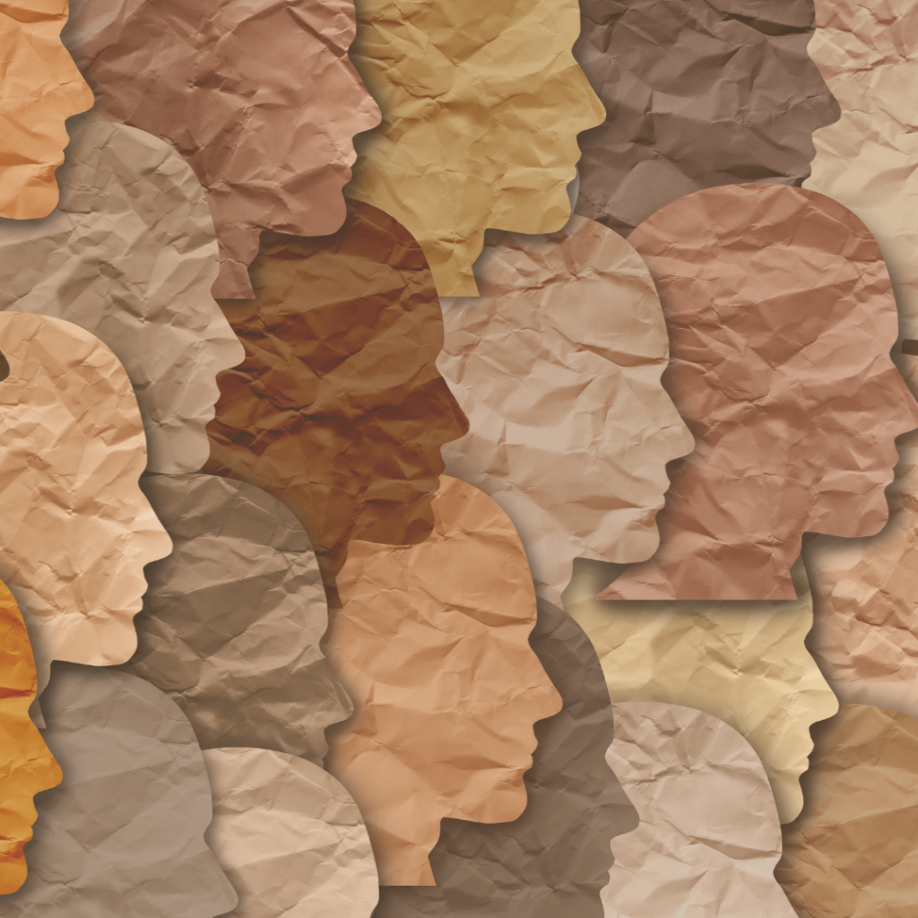Crumpled paper cutouts of diverse human silhouettes in shades of brown, beige, and tan overlapping each other.
