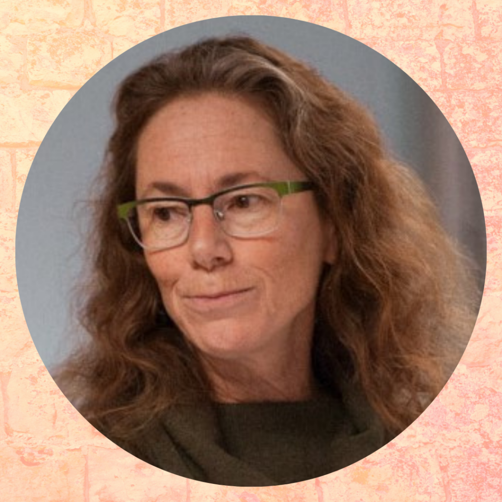 A woman with wavy brown hair and glasses looks to the side, against a light pink textured background.