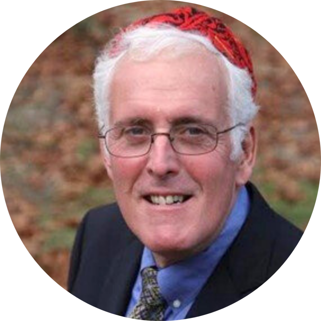 Elderly man with glasses, wearing a red hat and black suit, smiling outdoors.