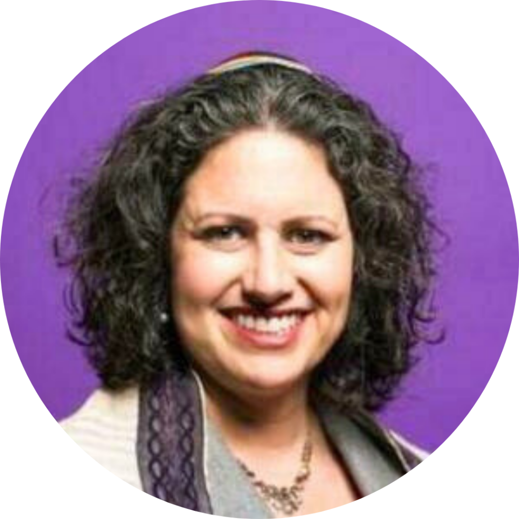 Smiling person with curly hair against a purple background.