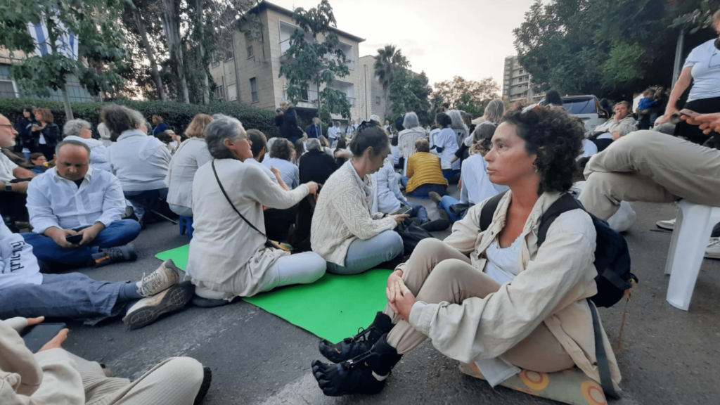 Peaceful protestors gathered in Jerusalem sitting on mats on the ground
