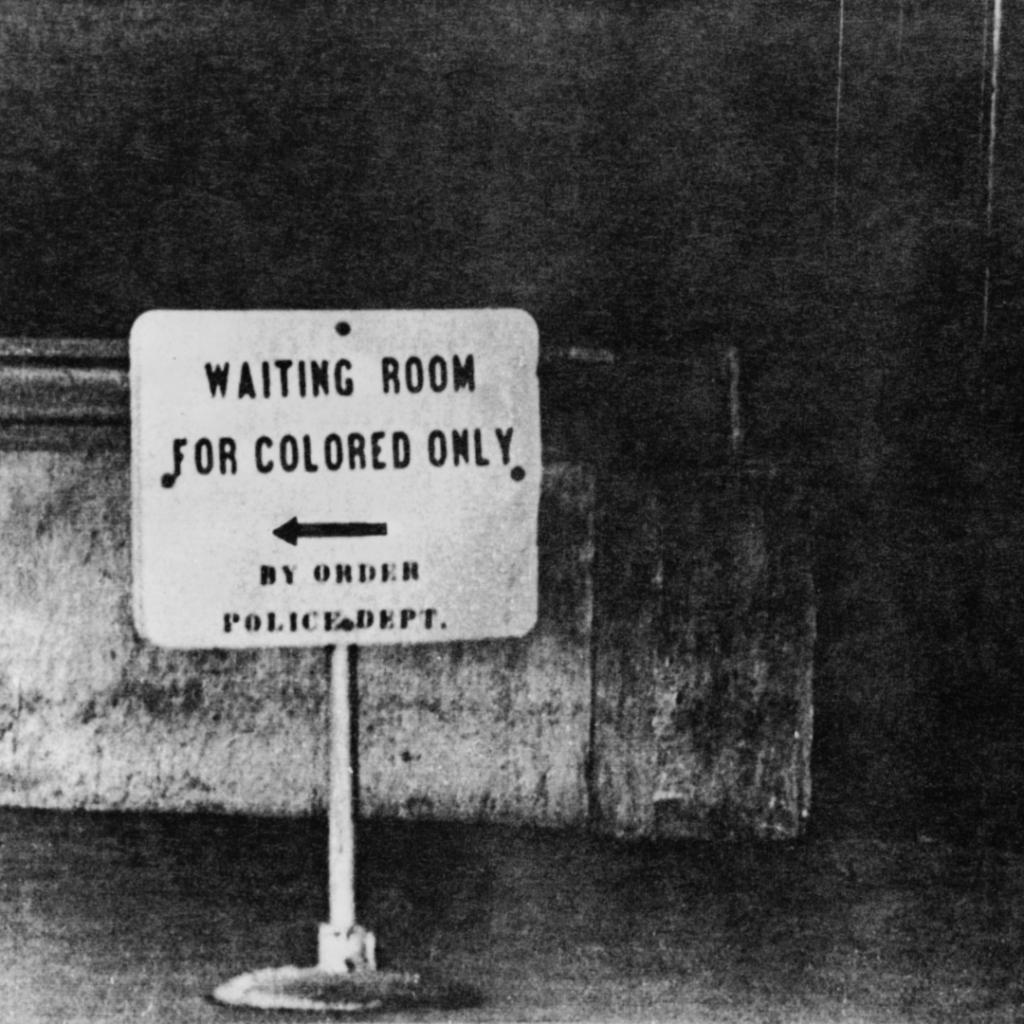 Sign reading Waiting Room for Colored Only with an arrow, from the era of racial segregation in the United States.
