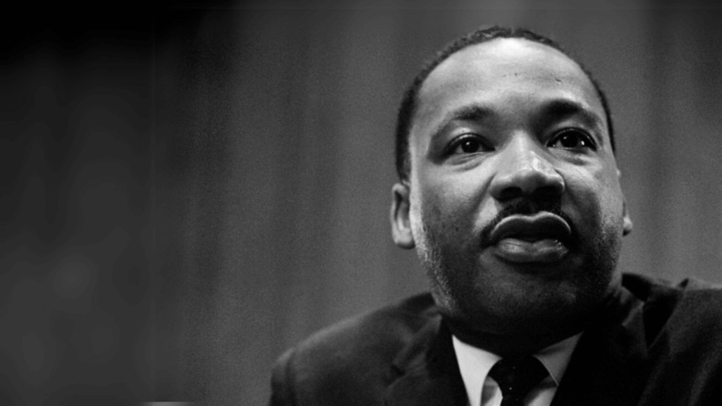 Martin Luther King, Jr. in black and white against a dark background